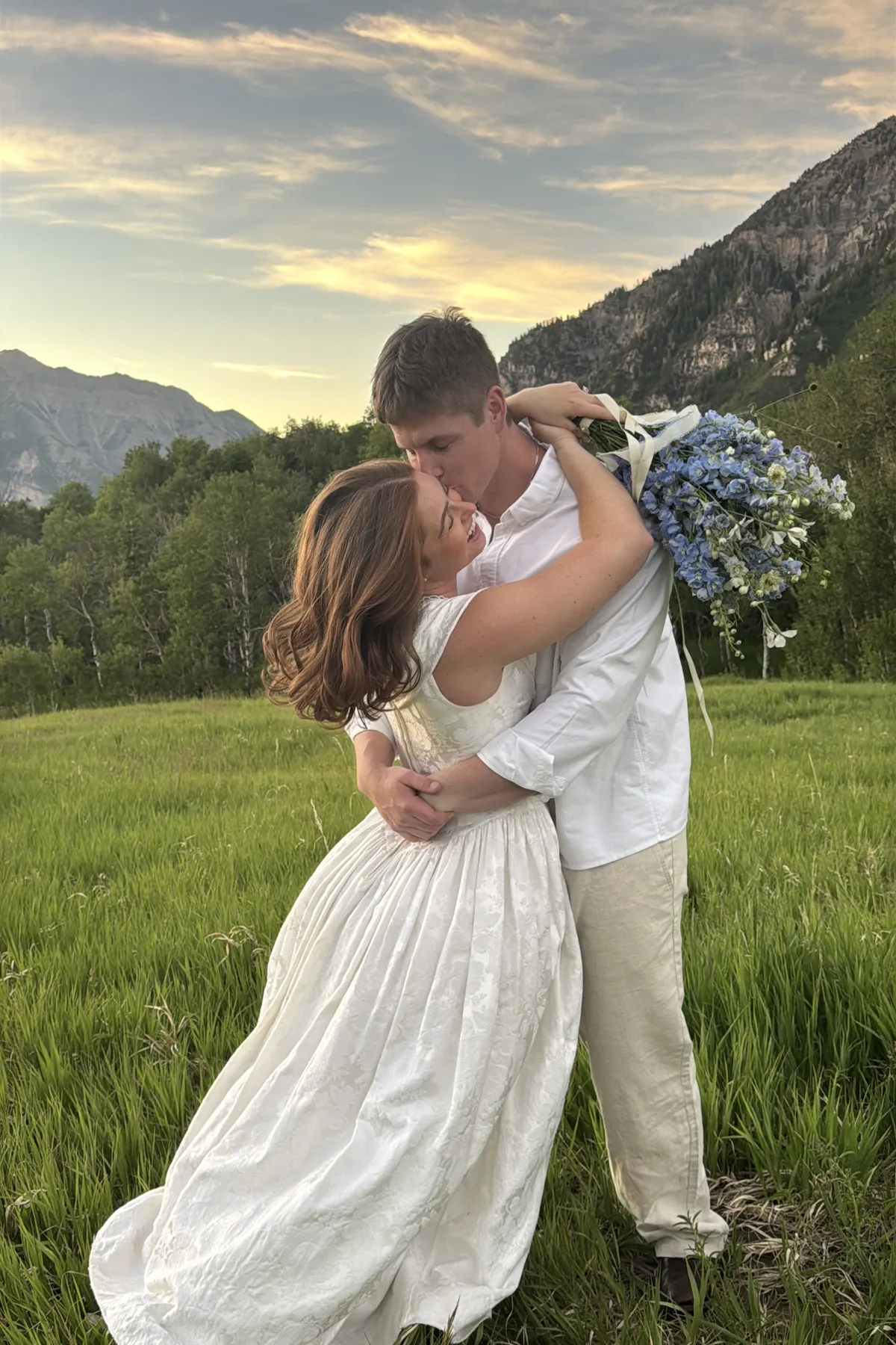 Couple embracing in a mountain meadow.
